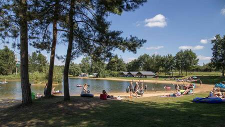 Mensen op het strand van het recreatiemeer op vakantiepark Molecaten Park Kuierpad