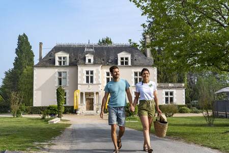 Een stel wandelt over vakantiepark Roompot Château des Marais