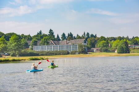 Mensen aan het kanoën op de recreatieplas van vakantiepark Roompot Klein Vink