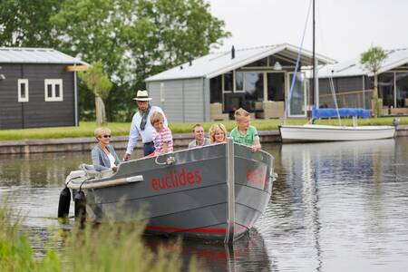 Sloep met mensen aan het varen op vakantiepark Roompot Waterpark Terkaple